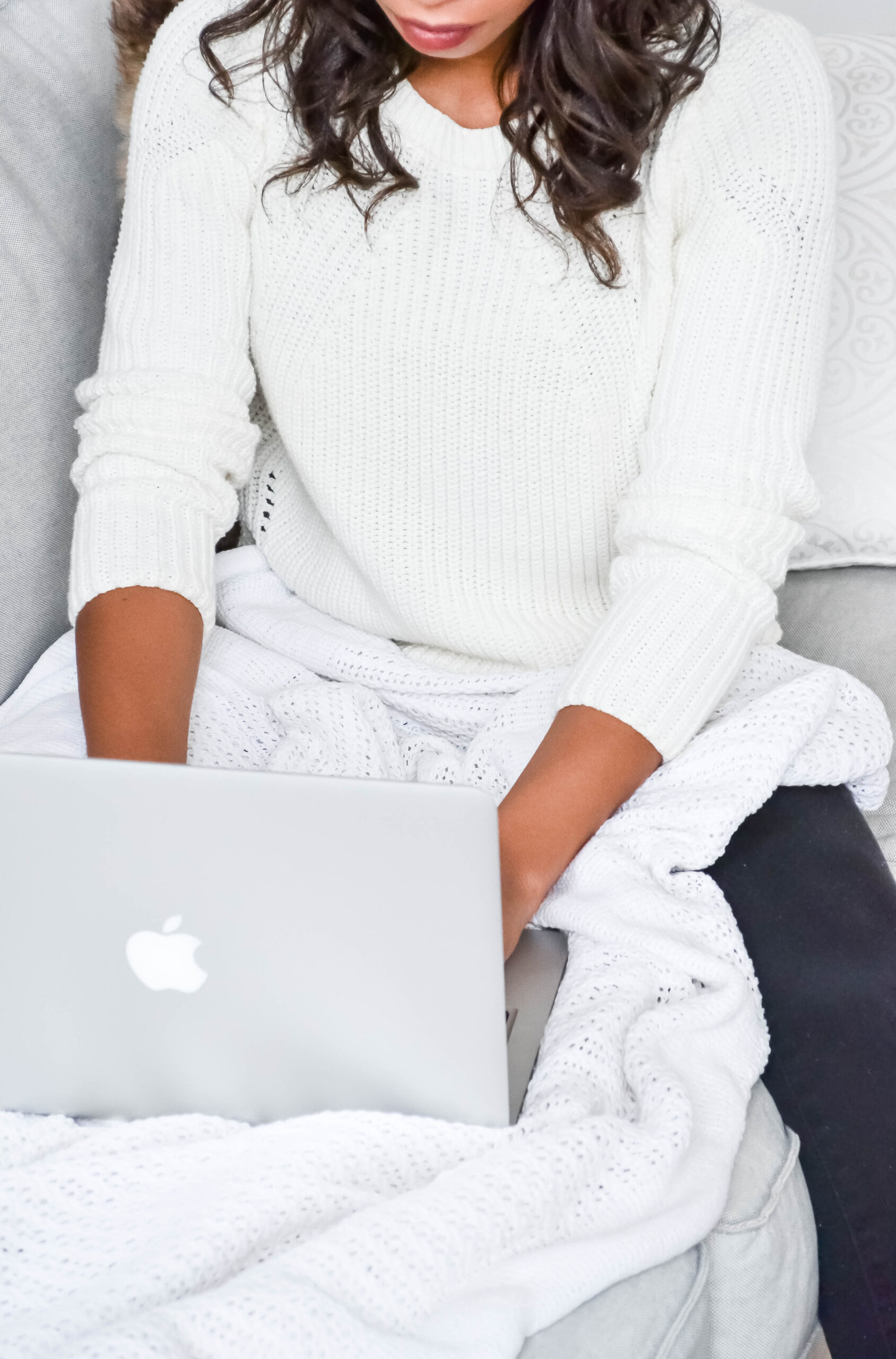 woman with laptop and blanket